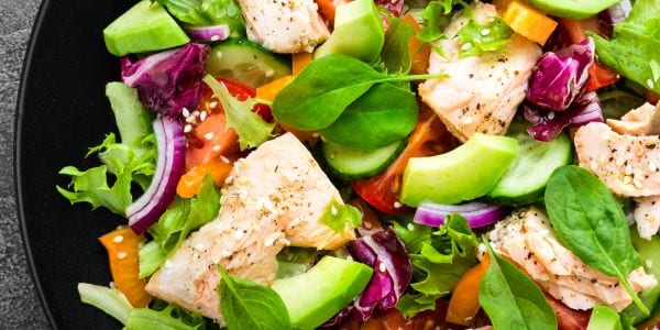 Image of a fresh, healthy salad with fish and lots of veggies.
