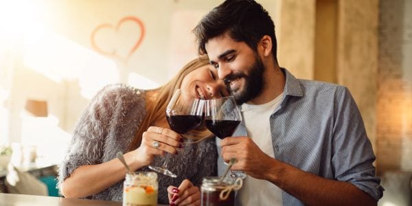 Cute couple toasting red wine on Valentine's Day.