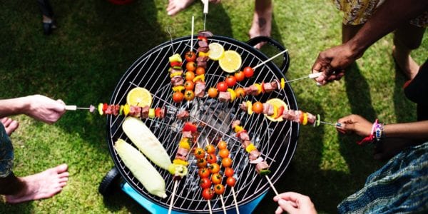 Adults grilling kabobs