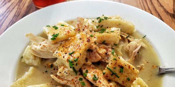 A bowl of chicken and dumplings.