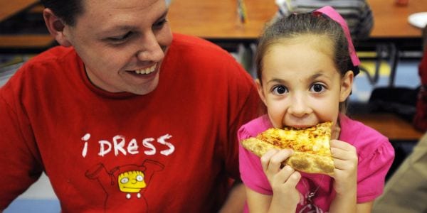 father eating pizza in a cafeteria with daughter