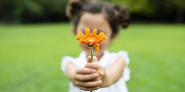 Little girl holding flower