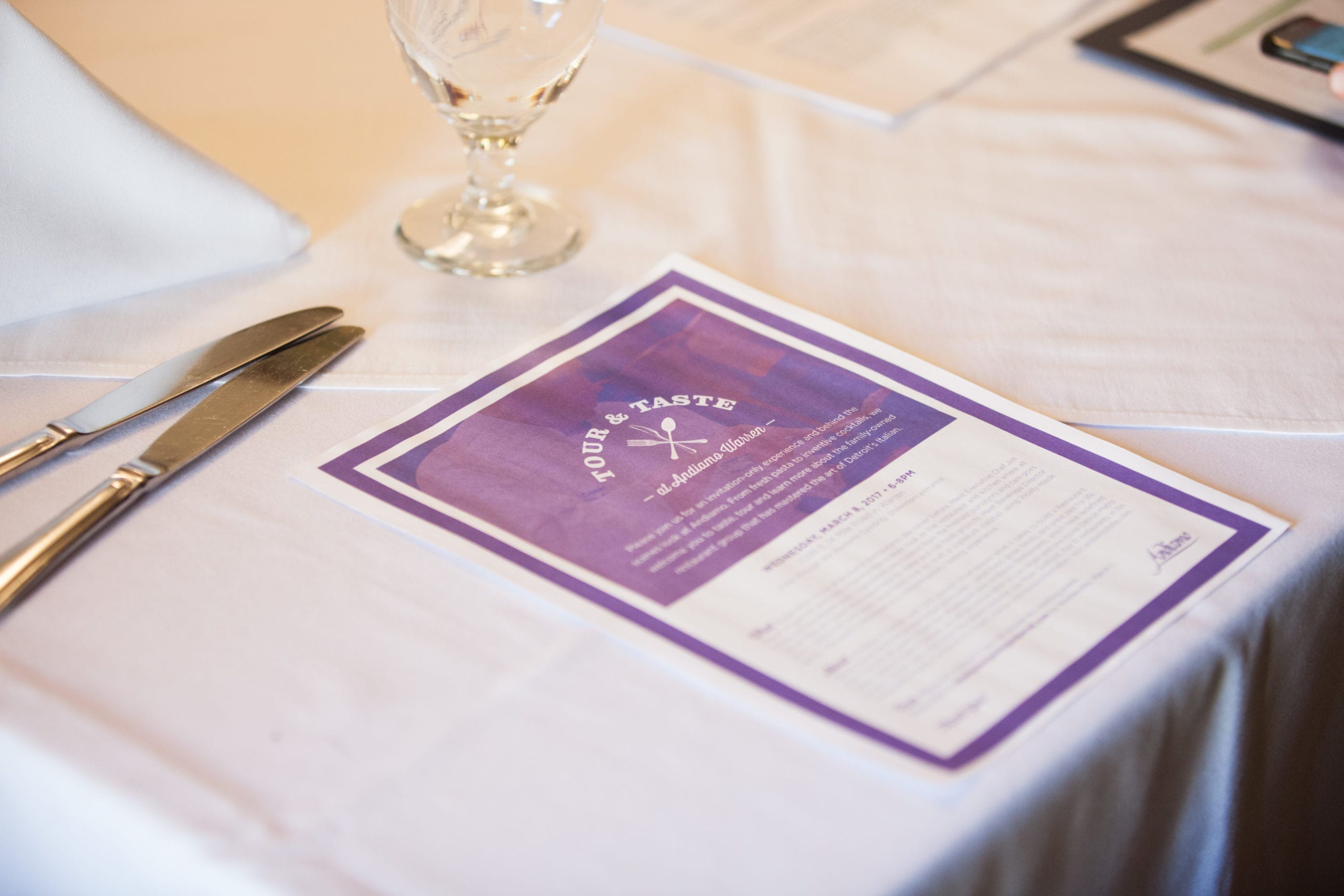 Purple and white menu on a cream colored table cloth