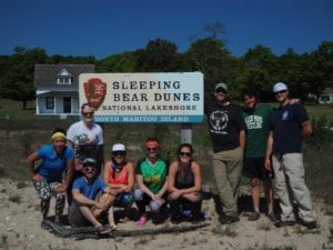the group in front of a sleeping bear dunes sign