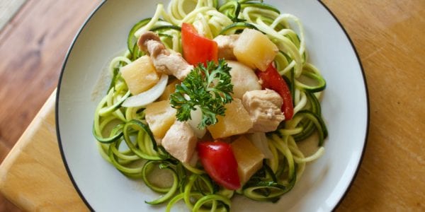 Complete dish of zoodles arranged on a white plate