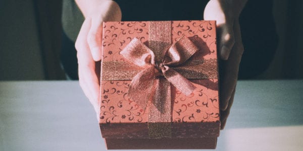 Close up of woman hands holding red gift box