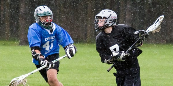 Two Lacrosse players competing hard