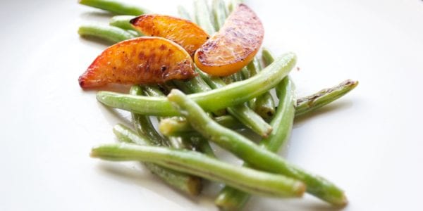 green beans and cooked peaches on plate