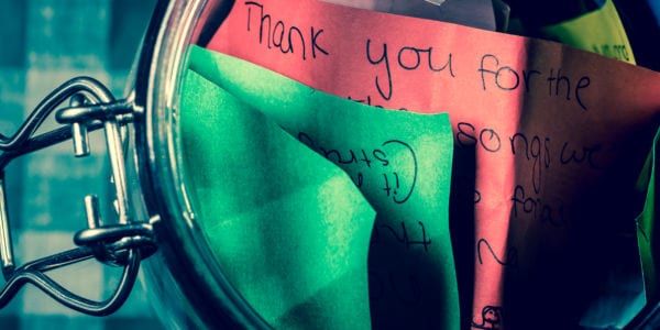 Thank you jar with messages written on coloured paper