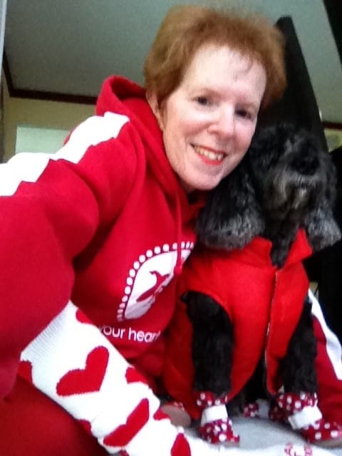 Susie Dubin with her dog, decked out in red gear to raise heart health awareness.