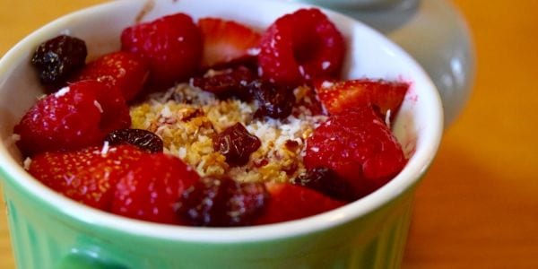 Chewy cherry oatmeal in a green bowl.