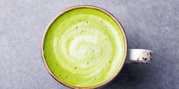 Matcha, green tea latte in a cup.