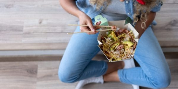 Woman eating takeout food
