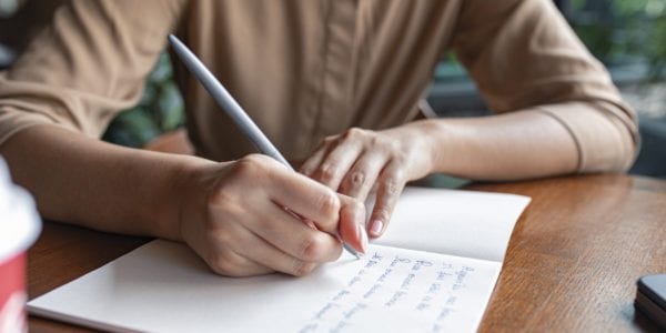 Man writing out his to-do list
