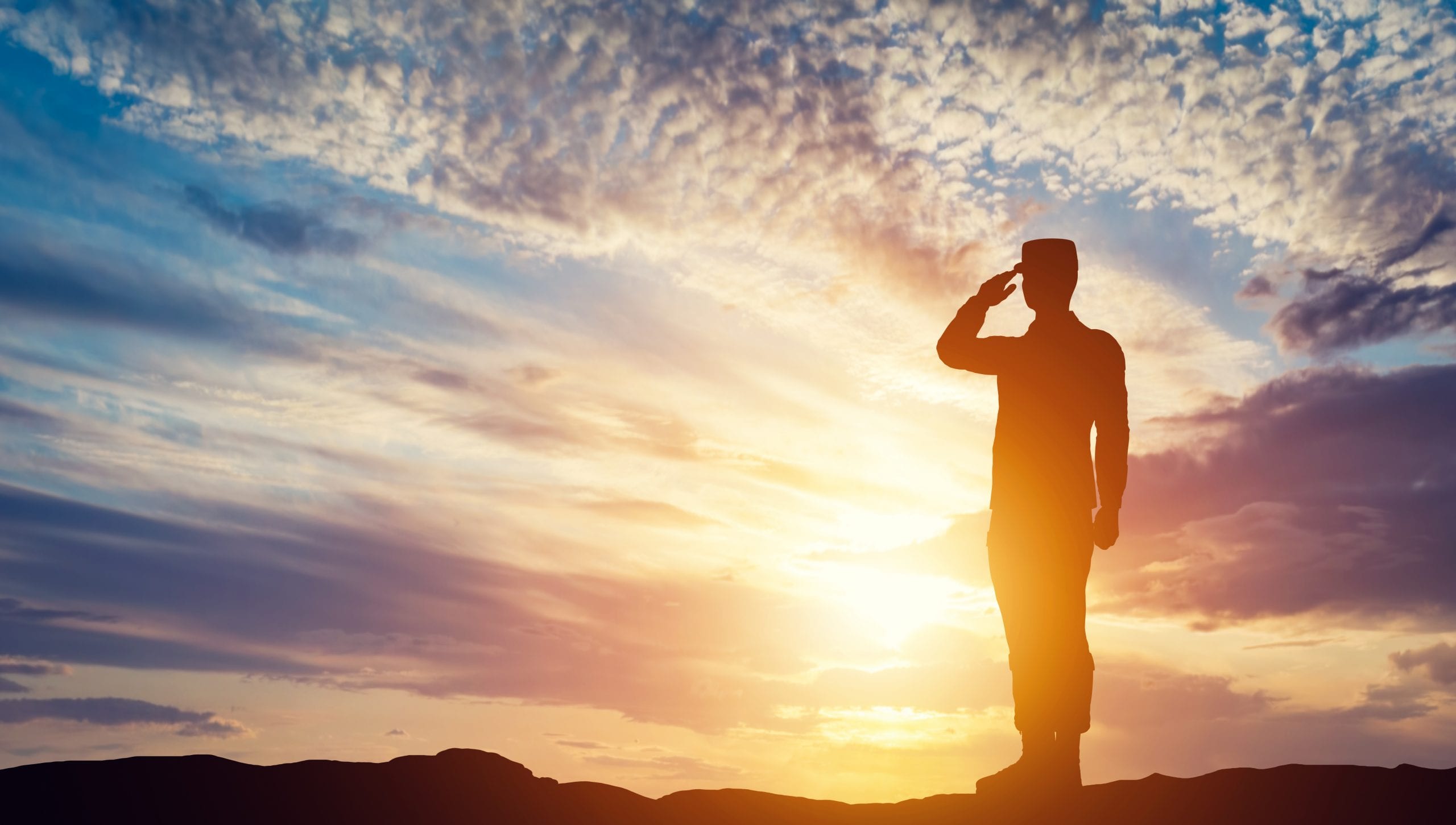 Soldier saluting at sunset. Army, salute, patriotic concept.