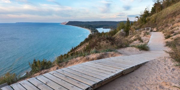 A weathered wooden walkway on the Empire Bluffs Trail is the perfect overlook to see Lake Michigan, the Sleeping Bear Dunes, and the Manitou island