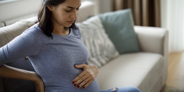Young pregnant woman suffering from backache