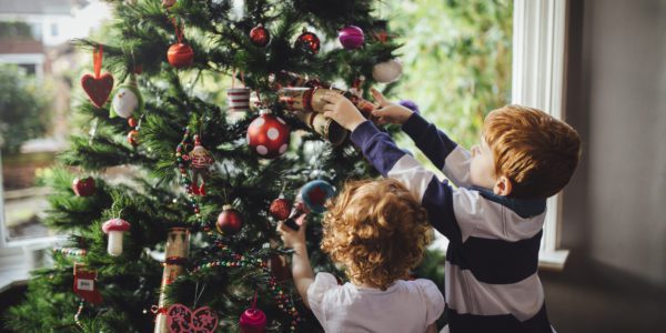 Kids decorate their Christmas tree.
