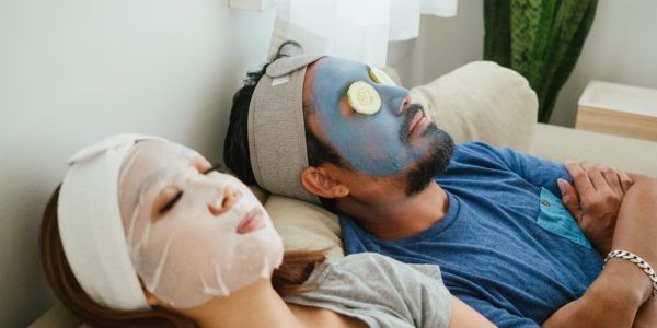 Happy couple doing facial mask.